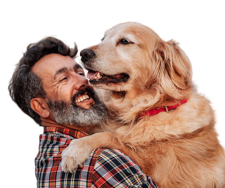 middle aged man hugging a very large and friendly golden retriever